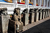 Bangkok Wat Arun - Detail of the precint of the sacred area of the ubosot with chinese noble woman sitting on chair. 